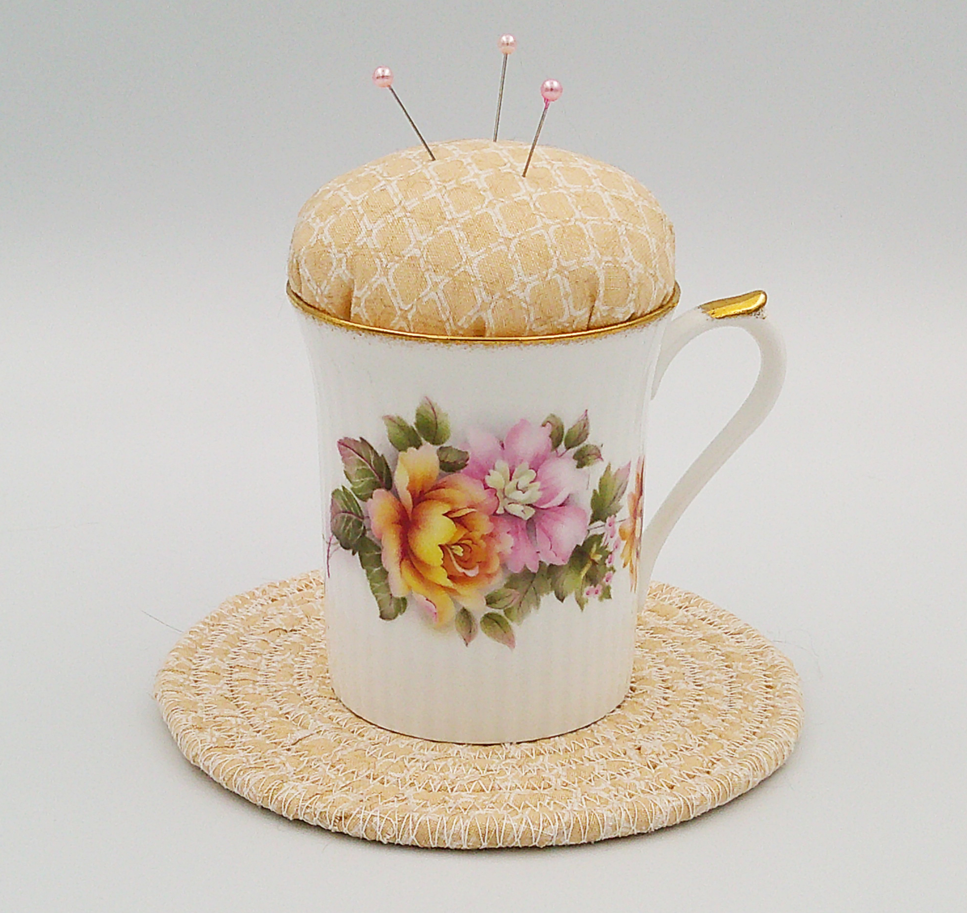 This is a frontal view of the teacup pincushion and trivet. The peonies are really pretty. This is a frontal view of the teacup pincushion and trivet. The peonies are really pretty.